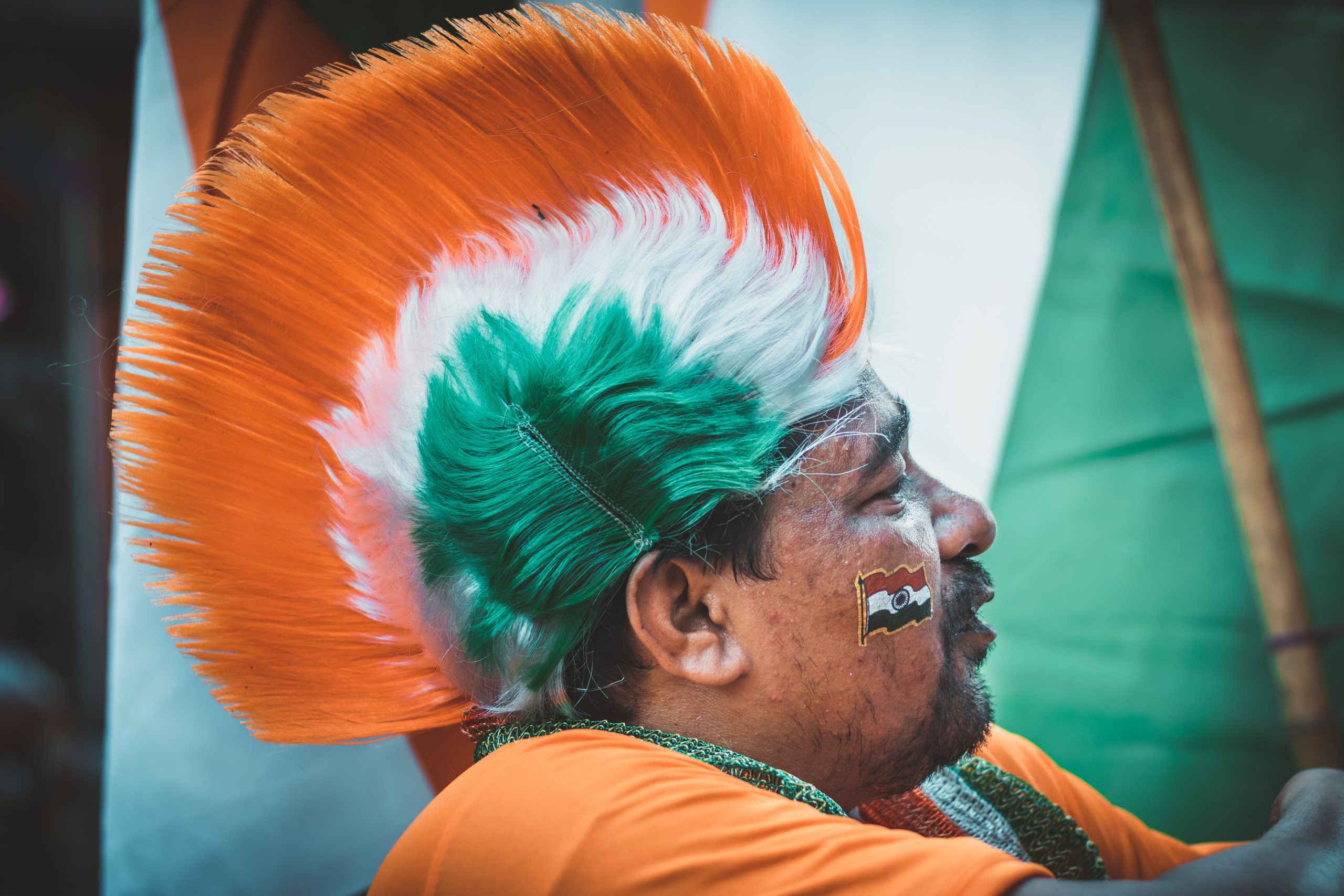 Indian man wearing India flag style hat on Independence Day