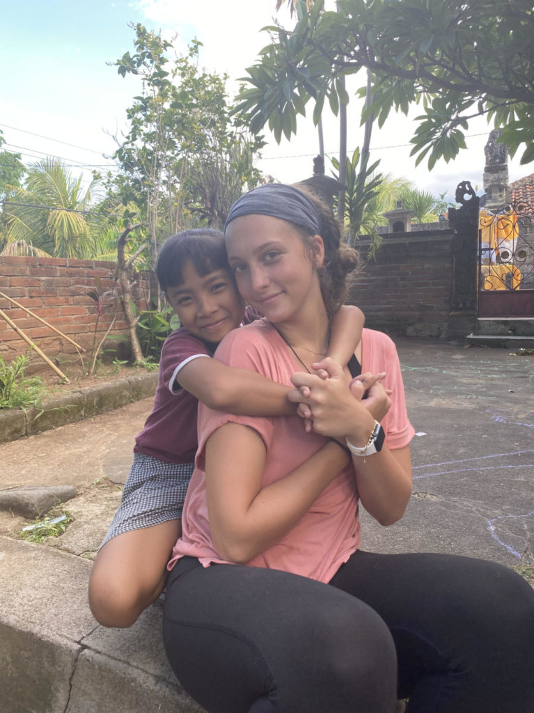 Volunteer with a child during a teaching and childcare project in Bali