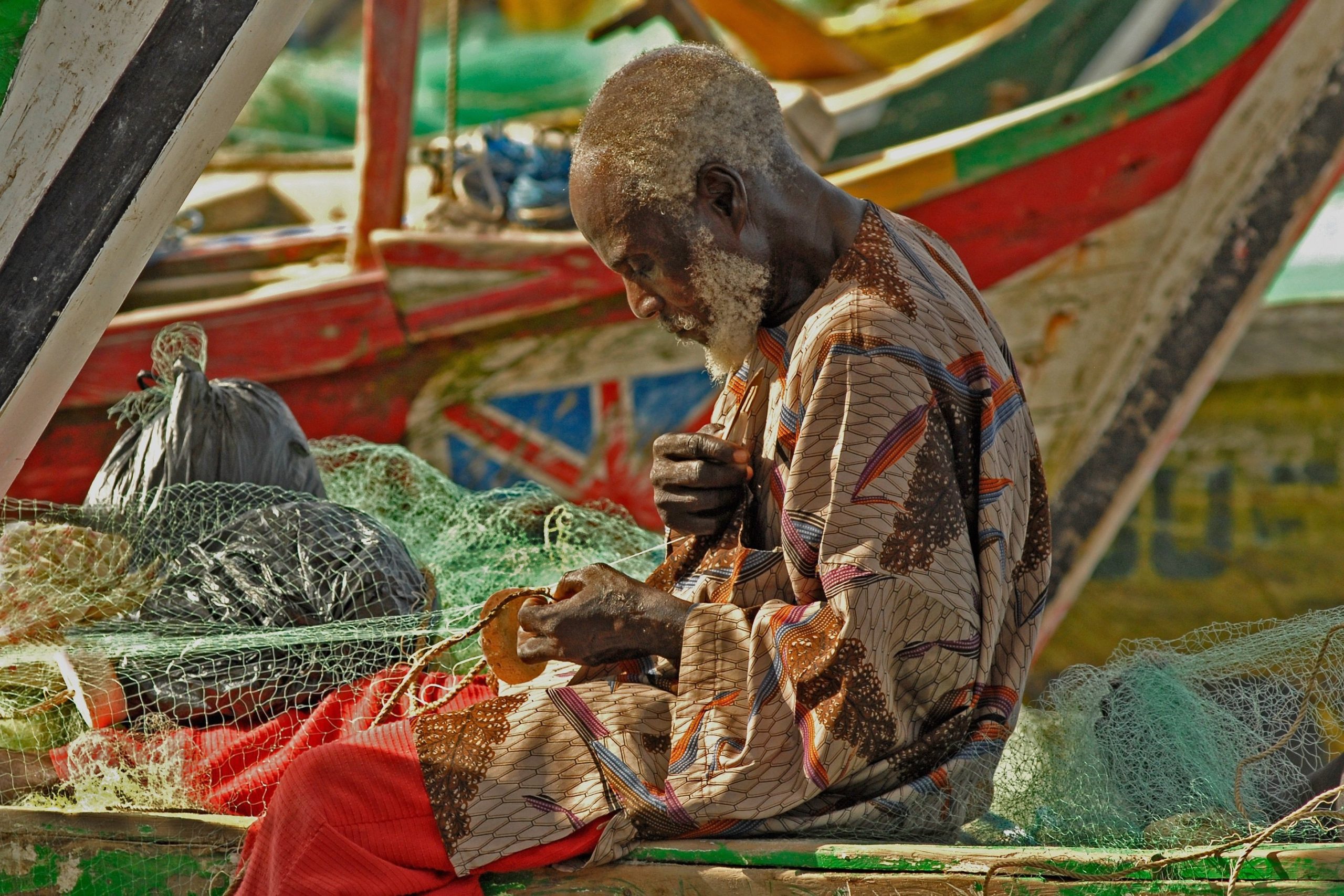 Ghanaian fisherman fixing nets
