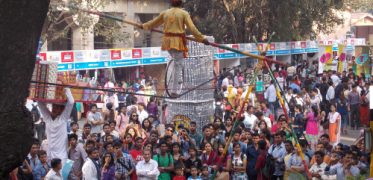 Traditional tightrope walker performing above a crowd at a festival in India