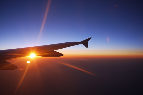 Sunset view from an aircraft window overlooking the clouds
