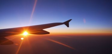 Sunrise view from an aeroplane window during an international journey