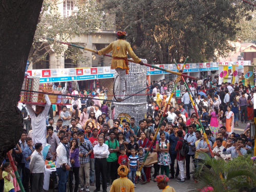 Crowds watching a traditional street performance during a festival in India