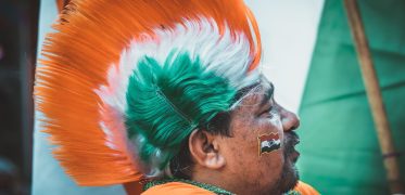 Indian man wearing India flag style hat on Independence Day